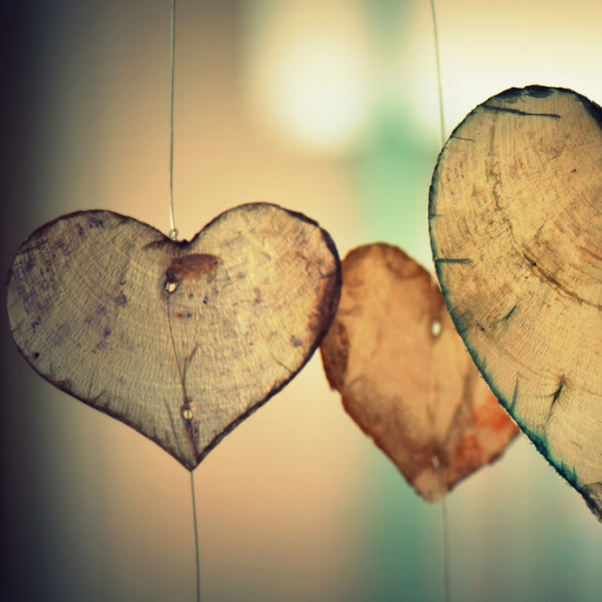 two hands intertwined displaying an engagement ring